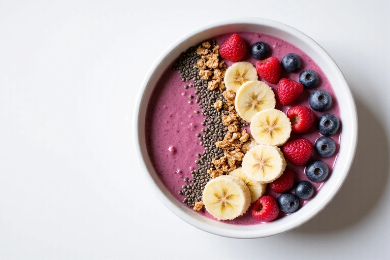 A vibrant smoothie bowl topped with fresh berries, nuts, and seeds, suggesting a healthy and delicious breakfast.